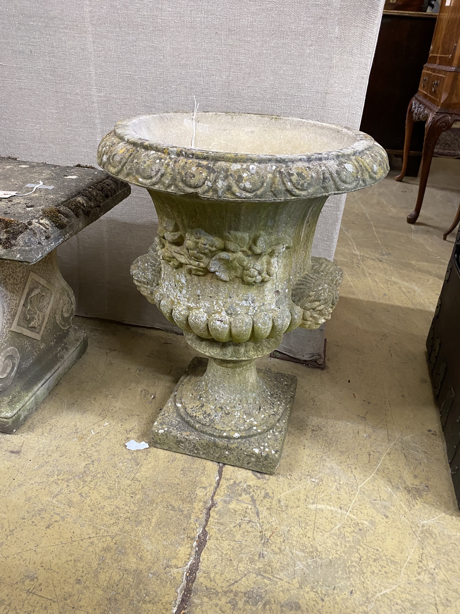 A circular reconstituted stone campana garden urn, diameter 50cm, height 64cm